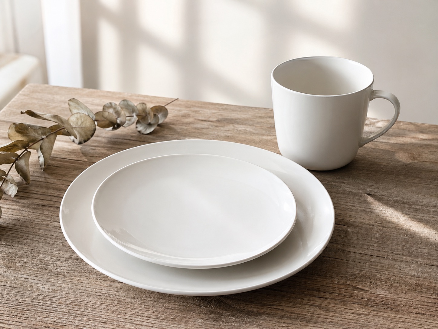 White porcelain dinnerware arranged on a linen tablecloth